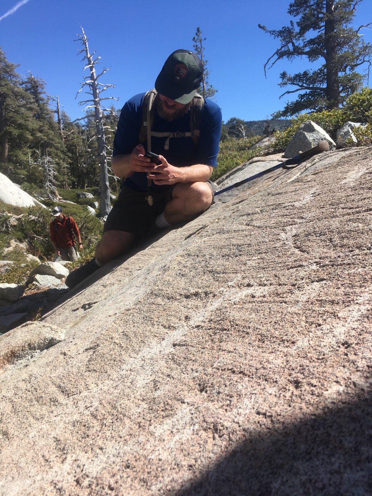 Examining a granite bedrock outcrop in the field