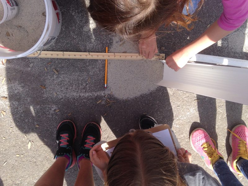 Students measuring the runout distance of the landslide deposit